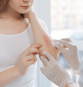 Dermatologist examining child’s skin for molluscum contagiosum