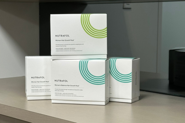 Nutrafol hair wellness products displayed at Revelus Dermatology in Austin.